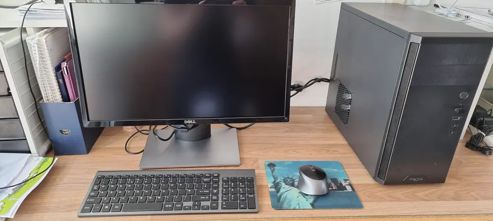 An office desk with a newly installed computer and monitor